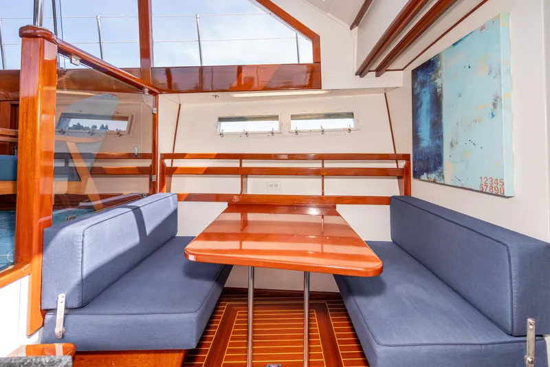 Slide: The Image of 1965 Chris-Craft 57 Constellation interior with wooden table, blue seating, and nautical decor. - 29