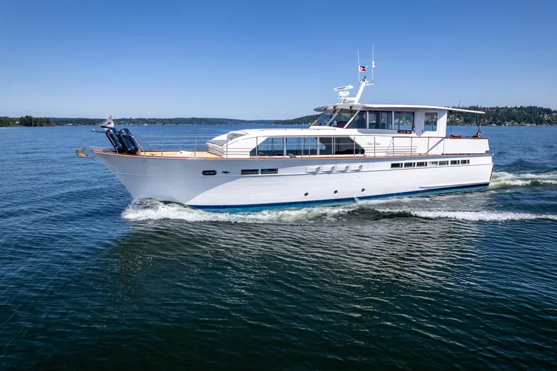 Slide: The Image of 1965 Chris-Craft 57 Constellation yacht cruising on open water under clear blue skies. - 3