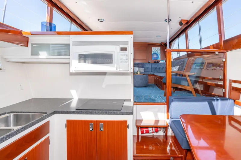 Slide: The Image of Interior of a 1965 Chris-Craft 57 Constellation yacht with modern kitchen and seating area. - 32