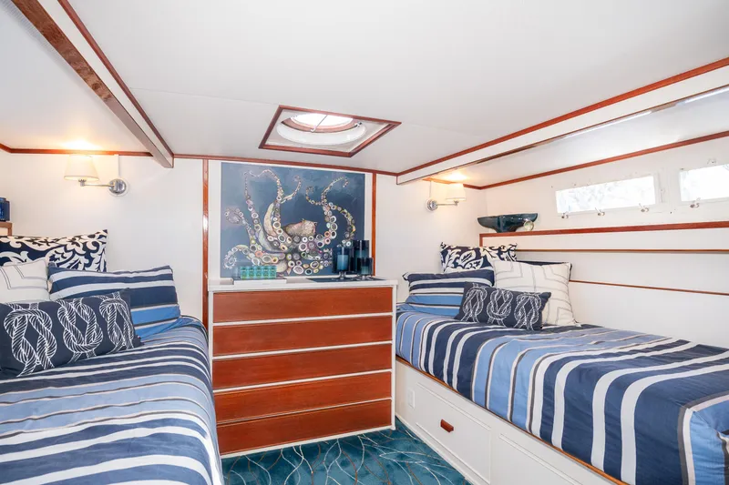 Slide: The Image of 1965 Chris-Craft 57 Constellation cabin with twin beds, nautical decor, and octopus artwork. - 34