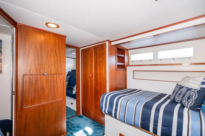 Slide: The Image of Luxurious cabin interior of 1965 Chris-Craft 57 Constellation yacht with wood paneling. - 38