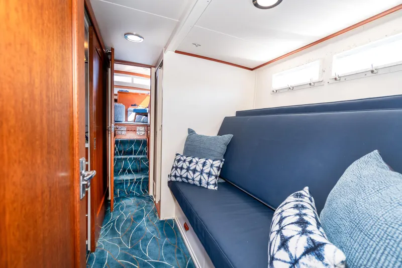 Slide: The Image of 1965 Chris-Craft 57 Constellation interior with blue seating and patterned pillows. - 42
