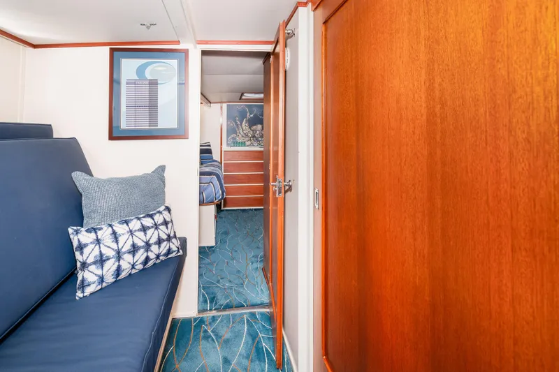 Slide: The Image of 1965 Chris-Craft 57 Constellation interior with blue seating, wooden paneling, and nautical decor. - 43