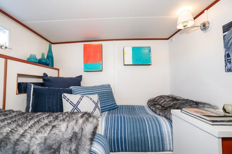 Slide: The Image of Cozy cabin interior of 1965 Chris-Craft 57 Constellation with modern decor and plush bedding. - 47