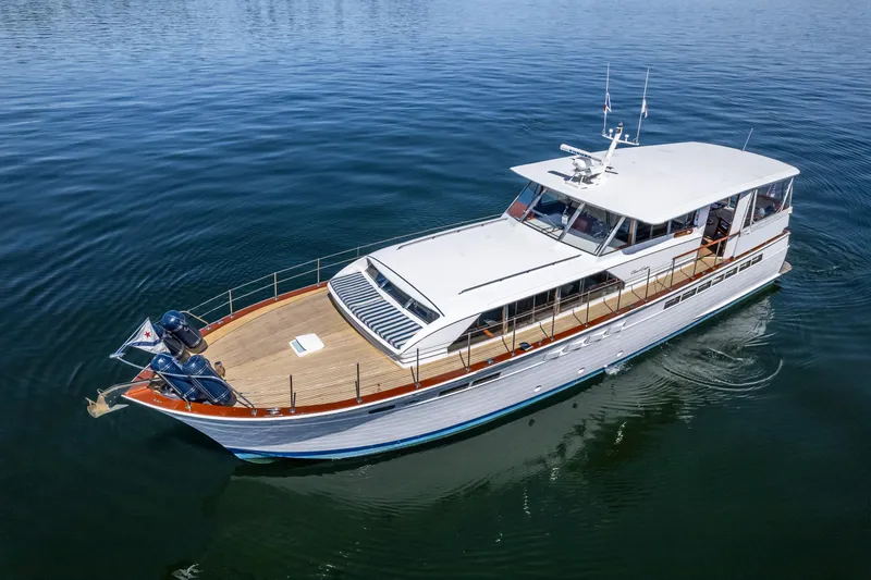 Slide: The Image of 1965 Chris-Craft 57 Constellation yacht on calm water, showcasing classic design and elegance. - 5