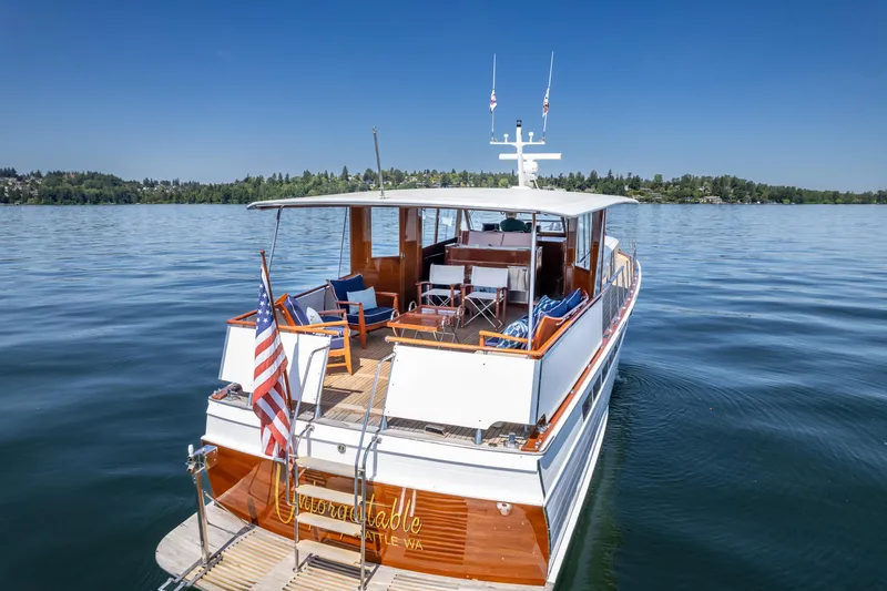 Slide: The Image of 1965 Chris-Craft 57 Constellation yacht on serene lake with clear blue sky. - 9