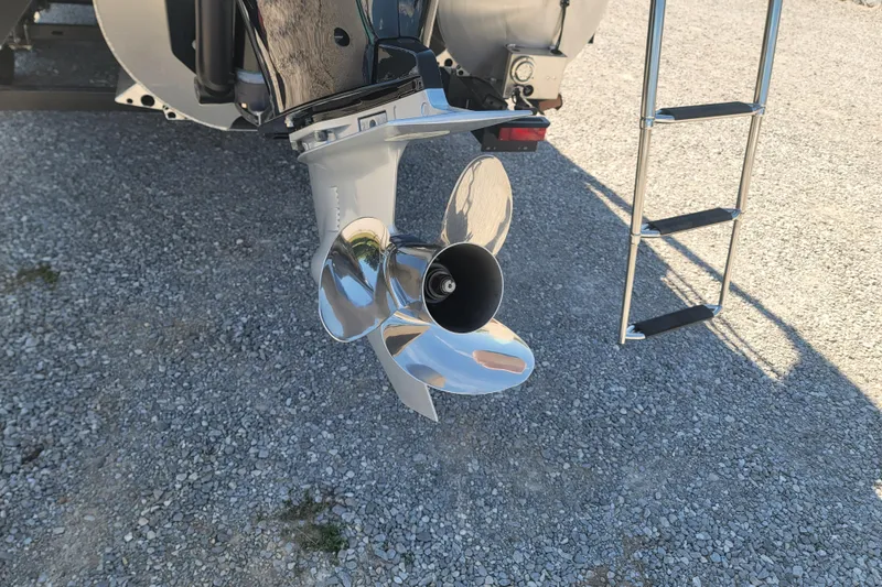 Slide: The Image of 2022 Barletta L23UC boat propeller and ladder on gravel surface. - 12