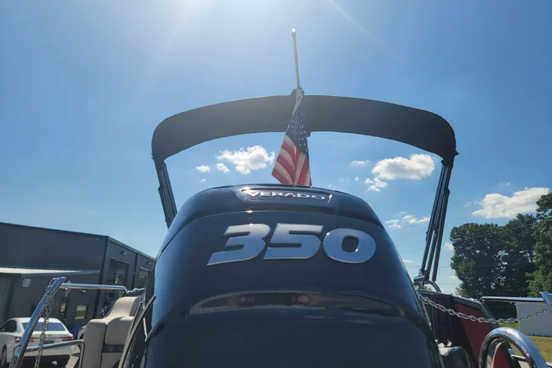 Slide: The Image of 2022 Barletta L23UC boat with Verado 350 engine, American flag, sunny day. - 13