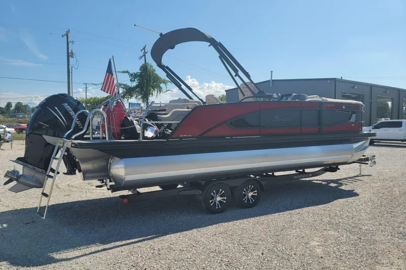 Slide: The Image of 2022 Barletta L23UC pontoon boat on trailer, featuring a sleek design and Mercury outboard motor. - 15
