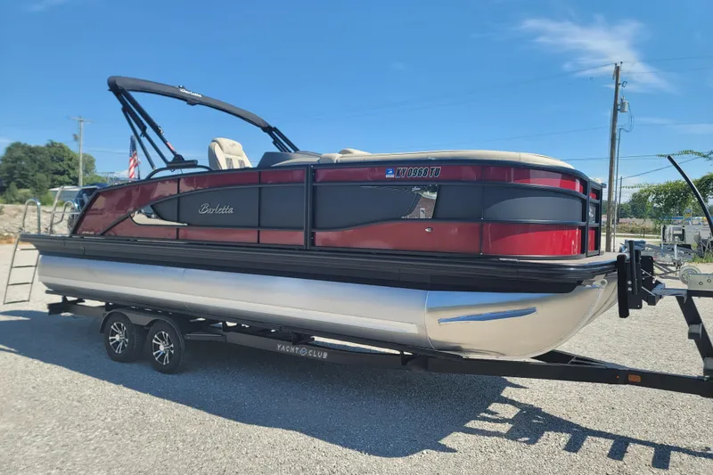 Slide: The Image of 2022 Barletta L23UC pontoon boat on trailer, sunny day, outdoor setting. - 16