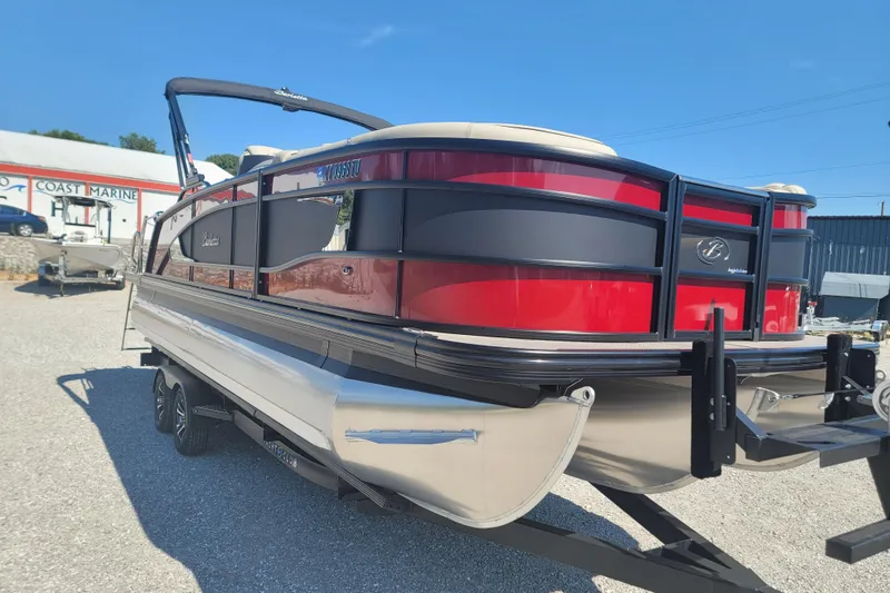Slide: The Image of 2022 Barletta L23UC pontoon boat with red and black exterior, parked at Coast Marine. - 18