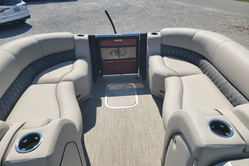Slide: The Image of 2022 Barletta L23UC pontoon boat interior with plush seating and cup holders. - 19
