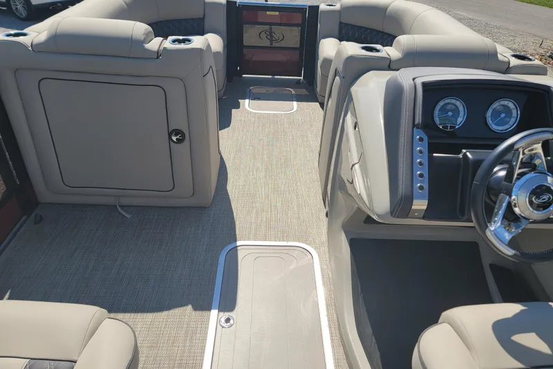 Slide: The Image of 2022 Barletta L23UC pontoon boat interior with plush seating and modern dashboard. - 20