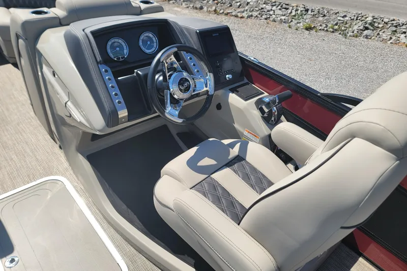 Slide: The Image of Luxurious 2022 Barletta L23UC boat interior with modern steering and dashboard controls. - 24