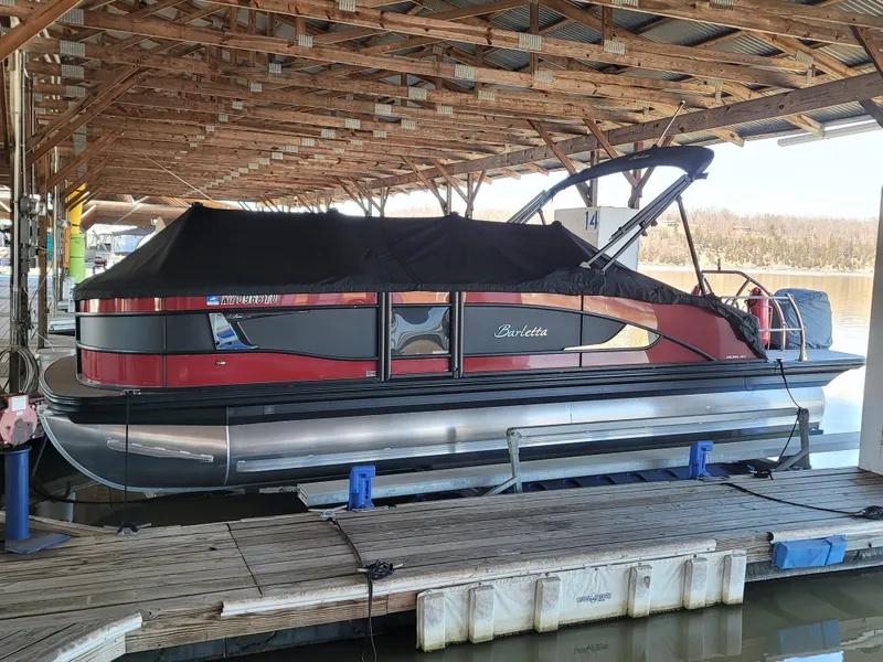 Slide: The Image of 2022 Barletta L23UC pontoon boat docked under a wooden canopy. - 30