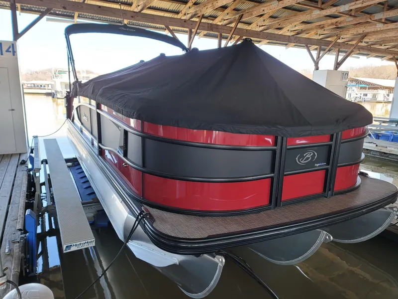 Slide: The Image of 2022 Barletta L23UC pontoon boat with cover, docked in a sheltered marina. - 33