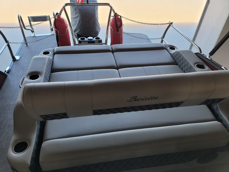 Slide: The Image of 2022 Barletta L23UC boat interior with cushioned seating and cup holders. - 35