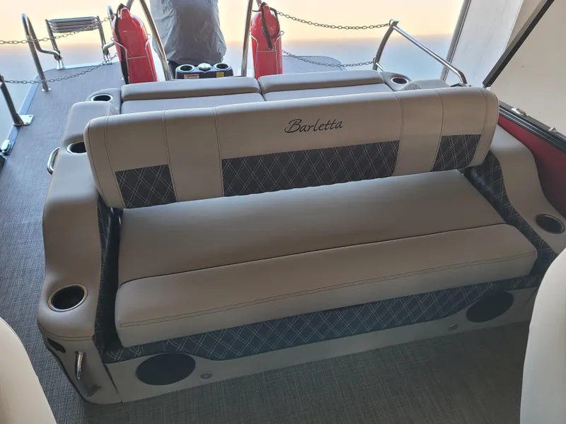 Slide: The Image of 2022 Barletta L23UC boat interior with plush seating and cup holders. - 40
