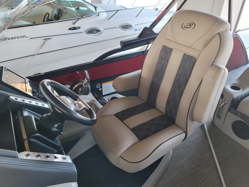 Slide: The Image of 2022 Barletta L23UC boat interior with luxury captain's chair and steering wheel. - 41