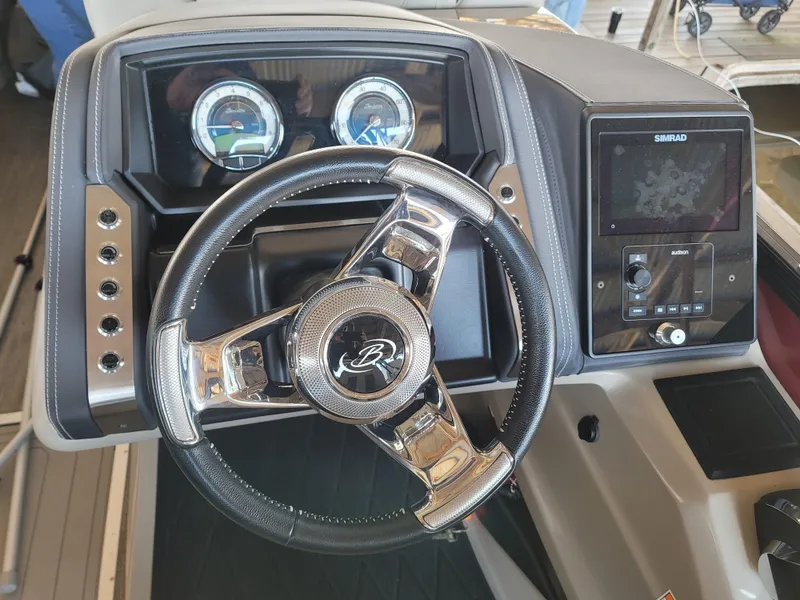 Slide: The Image of 2022 Barletta L23UC boat dashboard with steering wheel and navigation system. - 42