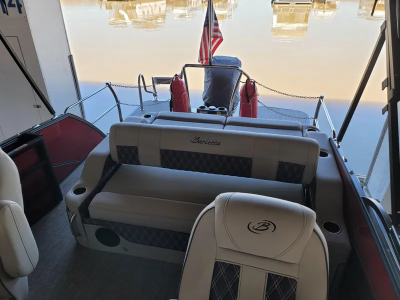Slide: The Image of 2022 Barletta L23UC pontoon boat interior with seating and American flag. - 43