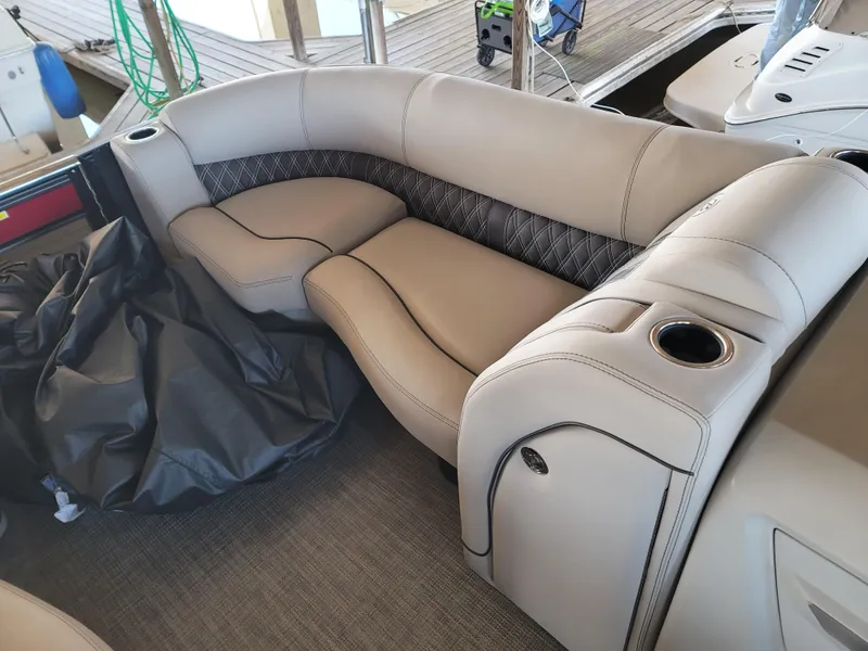 Slide: The Image of 2022 Barletta L23UC boat interior with plush seating and cup holders. - 44