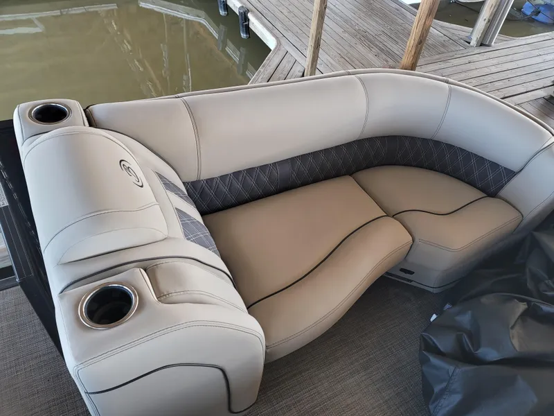 Slide: The Image of 2022 Barletta L23UC boat seating with cup holders, docked by the water. - 45