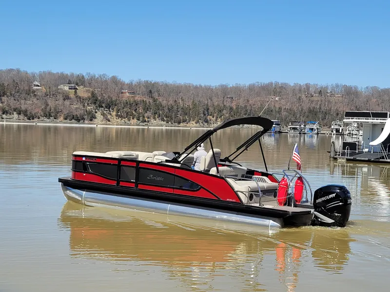 Slide: The Image of 2022 Barletta L23UC pontoon boat on a calm lake with scenic background. - 49