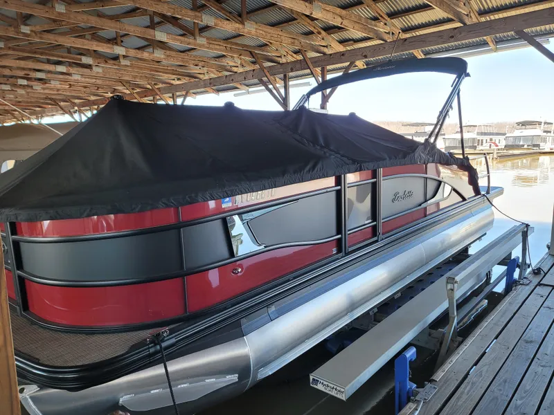 Slide: The Image of 2022 Barletta L23UC pontoon boat under a covered dock. - 6