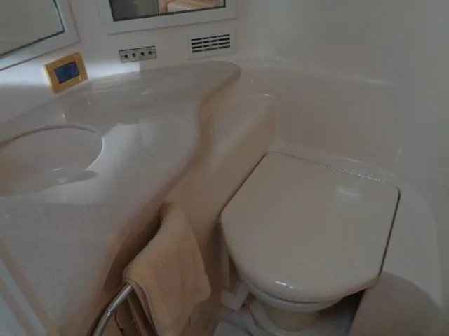 Slide: The Image of 1999 Sea Ray 400 Sundancer bathroom with toilet and sink. - 11