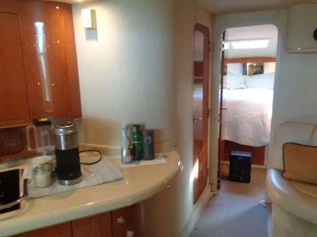 Slide: The Image of Interior of 1999 Sea Ray 400 Sundancer yacht with kitchenette and bedroom. - 15