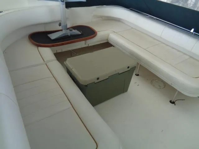 Slide: The Image of 1999 Sea Ray 400 Sundancer interior with white seating and a central table. - 18
