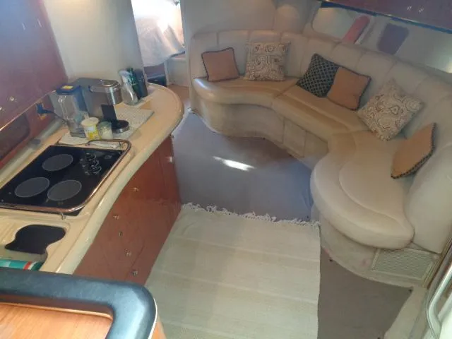 Slide: The Image of Interior of 1999 Sea Ray 400 Sundancer yacht with kitchen and seating area. - 2