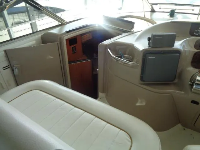 Slide: The Image of 1999 Sea Ray 400 Sundancer interior with helm, seating, and navigation equipment. - 20