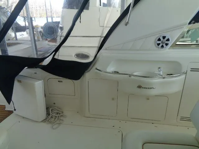 Slide: The Image of Interior view of a 1999 Sea Ray 400 Sundancer yacht with sink and storage. - 21