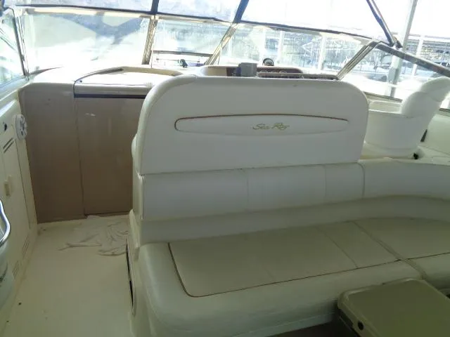 Slide: The Image of 1999 Sea Ray 400 Sundancer interior with white seating and helm area. - 23