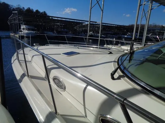 Slide: The Image of 1999 Sea Ray 400 Sundancer yacht docked at marina under clear blue sky. - 24