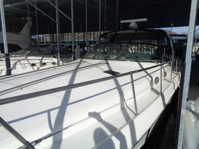 Slide: The Image of 1999 Sea Ray 400 Sundancer yacht docked under a covered marina. - 25