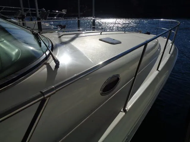Slide: The Image of 1999 Sea Ray 400 Sundancer yacht on water, sunlit deck and railing. - 30