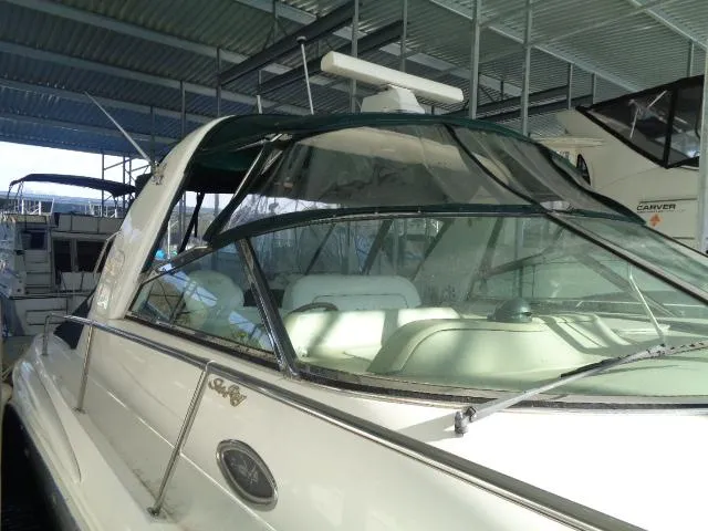 Slide: The Image of 1999 Sea Ray 400 Sundancer yacht docked in a covered marina. - 32