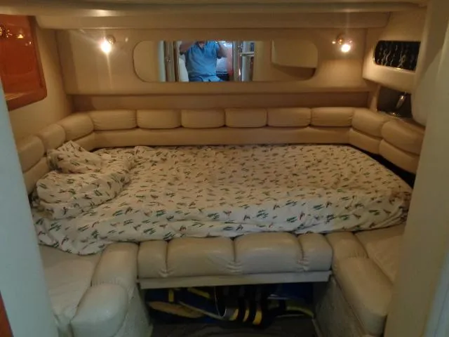 Slide: The Image of 1999 Sea Ray 400 Sundancer cabin with cozy bed and ambient lighting. - 5
