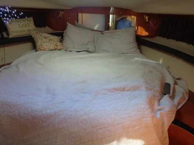 Slide: The Image of Cozy bedroom interior of 1999 Sea Ray 400 Sundancer yacht with pillows and blanket. - 9