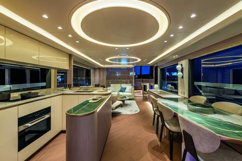 Slide: The Image of Luxurious interior of 2025 Absolute 70 Navetta yacht with modern kitchen and dining area. - 12