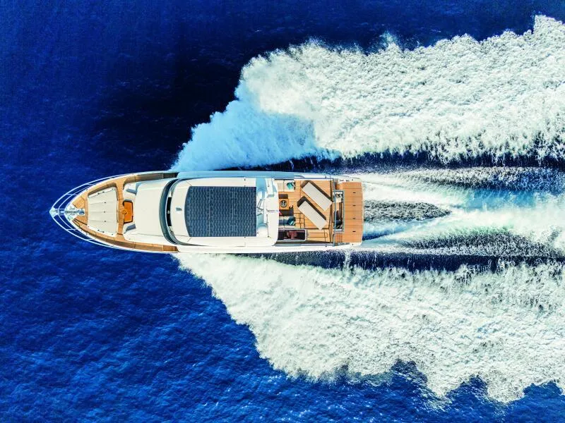 Slide: The Image of Aerial view of 2025 Absolute 70 Navetta yacht cruising on blue ocean waters. - 31