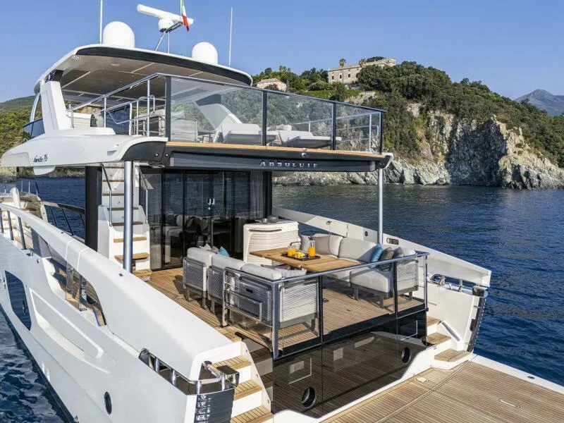 Slide: The Image of Luxurious 2025 Absolute 70 Navetta yacht with spacious deck, scenic coastal backdrop. - 35