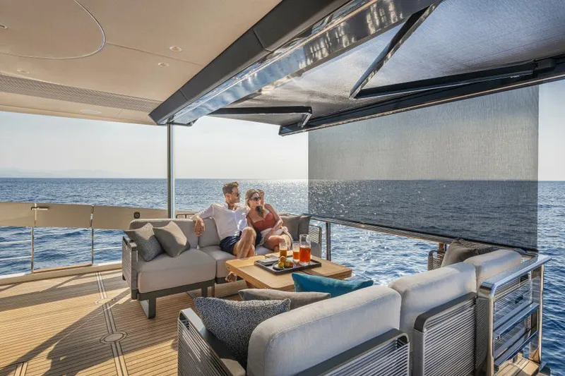 Slide: The Image of Couple relaxing on Absolute 70 Navetta yacht, 2025 model, enjoying ocean view. - 6