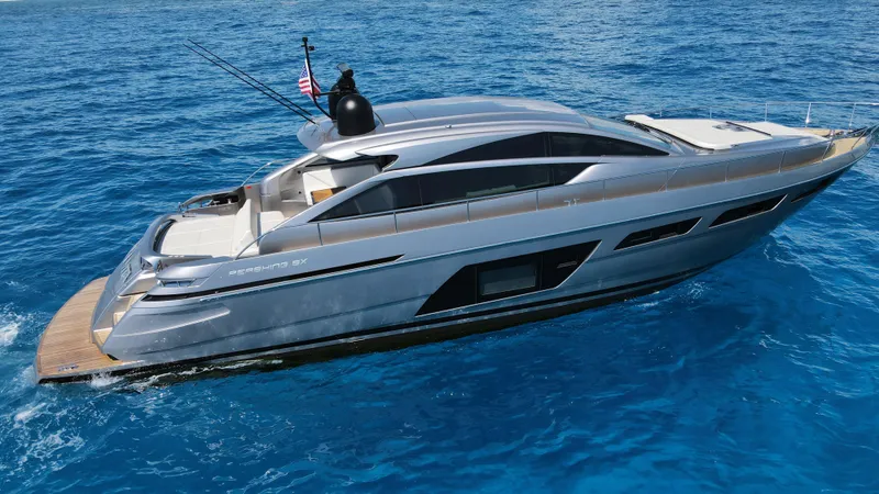 Slide: The Image of 2022 Pershing 6X yacht cruising on clear blue ocean waters. - 11