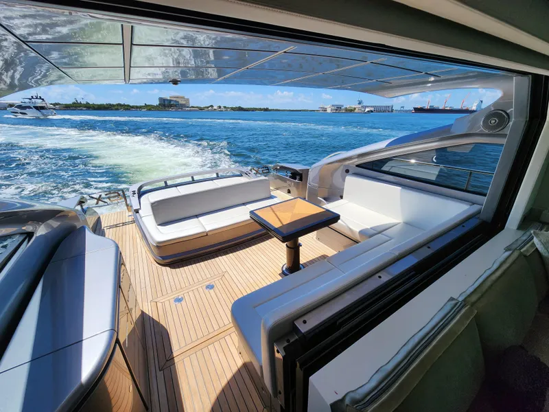 Slide: The Image of 2022 Pershing 6X yacht interior with ocean view, featuring sleek seating and modern design. - 12