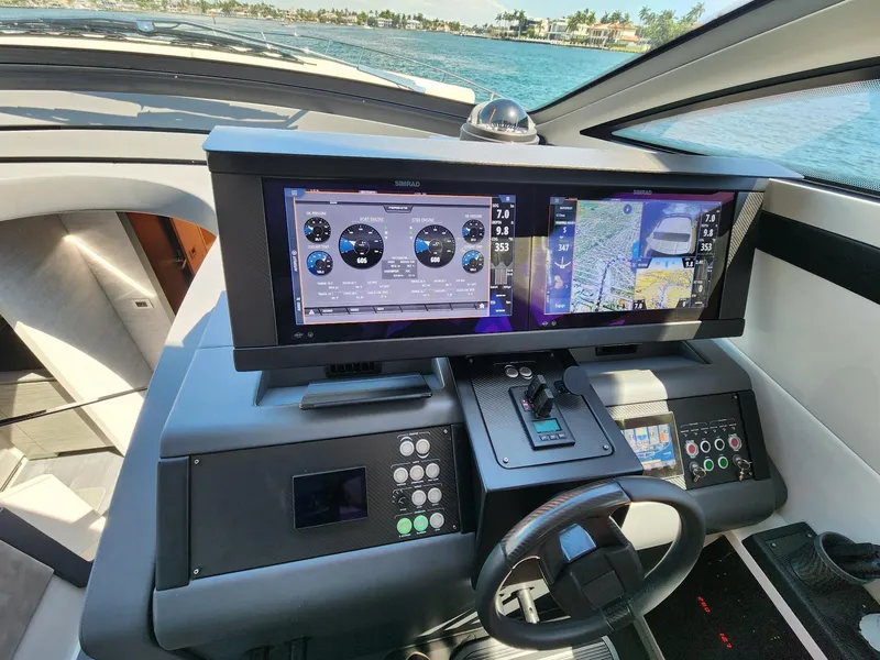 Slide: The Image of Cockpit of 2022 Pershing 6X yacht with advanced navigation displays and controls. - 19