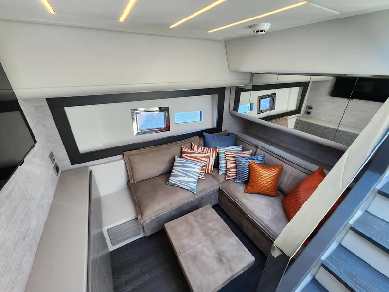 Slide: The Image of Luxurious interior of 2022 Pershing 6X yacht with modern seating and colorful cushions. - 20